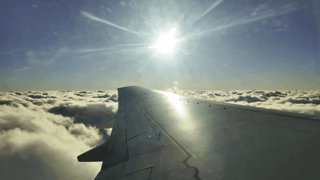 View of airplane wing above the clouds