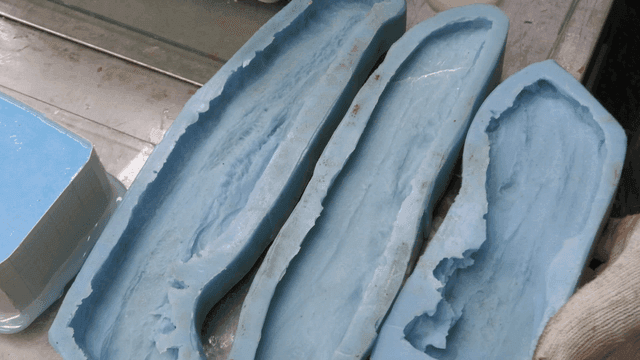Blue silicone molds on a metal table