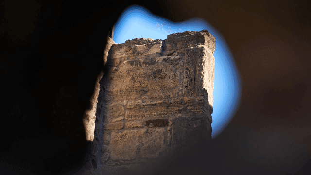 Ancient stone wall under clear blue sky