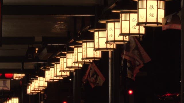 Traditional Asian lanterns hanging from street structures at night