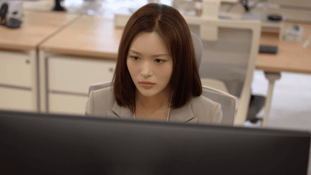 Female office worker concentrating on her monitor in office
