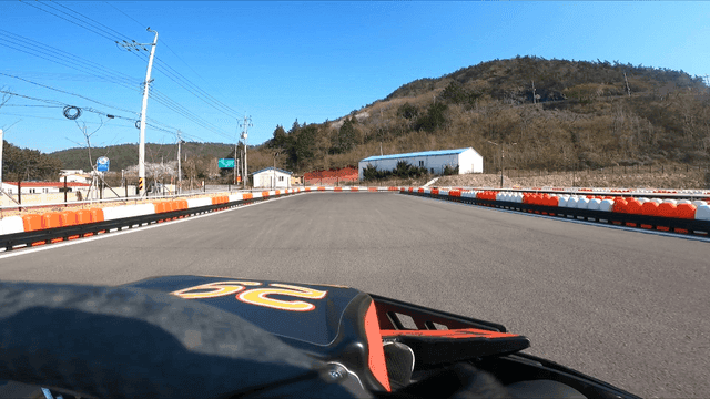 Go-kart racing on a sunny outdoor track