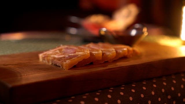 Tasting cold cuts plated on a wooden cutting board with chopsticks