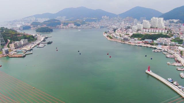 Coastal city with cable cars and a bridge