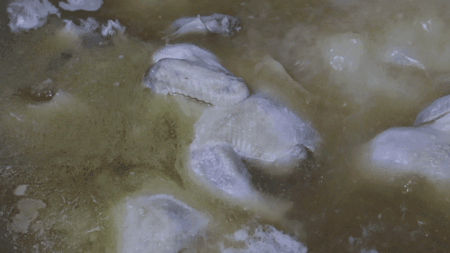 Chicken pieces boiling in broth