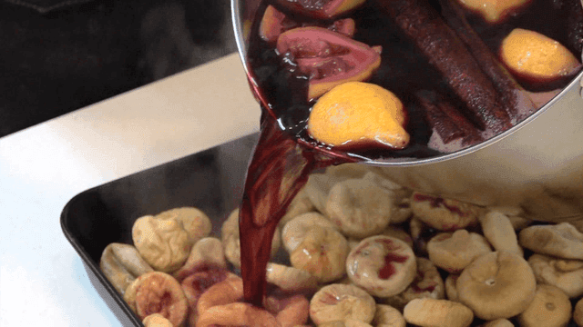 Mulled wine being poured over dried figs