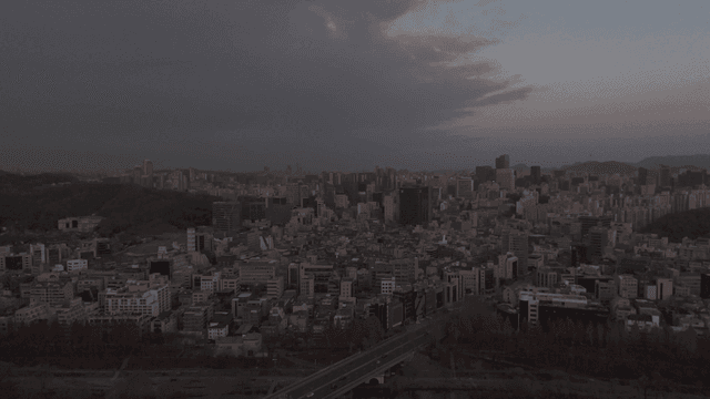 Evening city view under cloudy sky