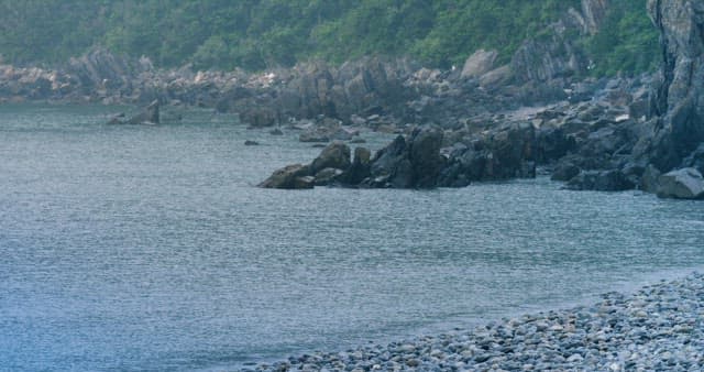 Serene Rocky Seashore Landscape with Calm Waves