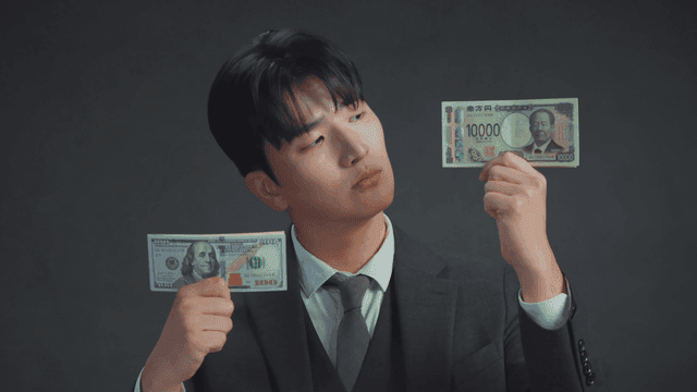 Man smiling at the US dollar bills in his hand