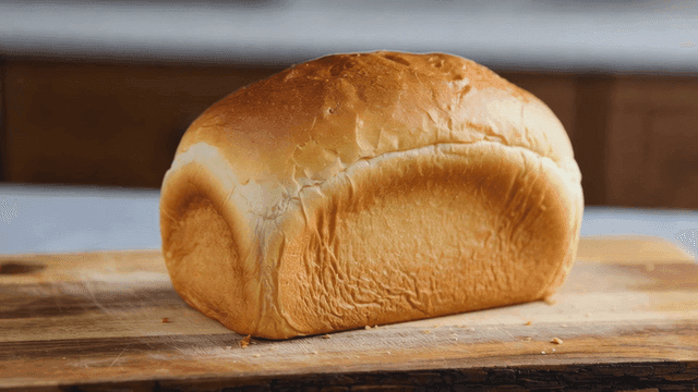 Freshly baked loaf of bread on a wooden board