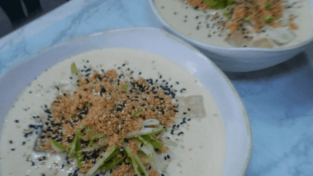 Cold Soybean Noodles Topped with Sesame Seeds and Cucumber