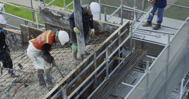 Construction workers pouring concrete