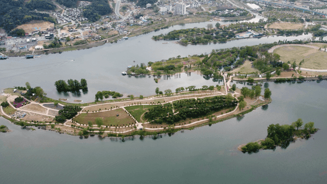 Aerial view of a river with surrounding park
