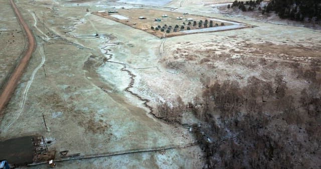 Vast fields with scattered buildings