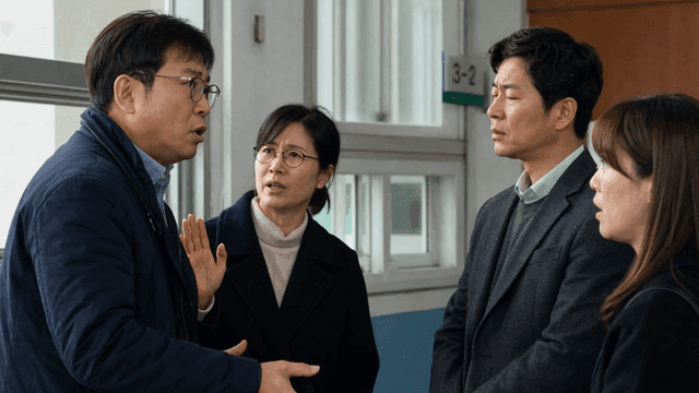 Teachers discussing in a school hallway