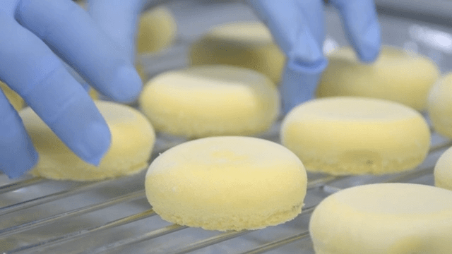 Freshly baked yellow cakes on a cooling rack