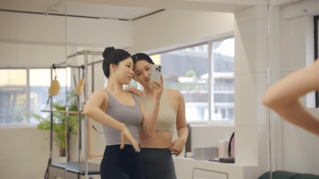Two women taking a selfie in a fitness studio