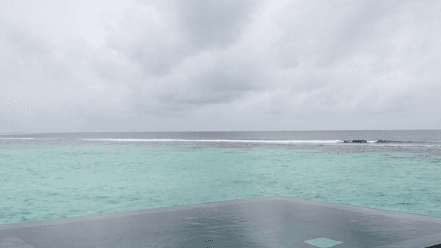 A calm ocean under a cloudy sky
