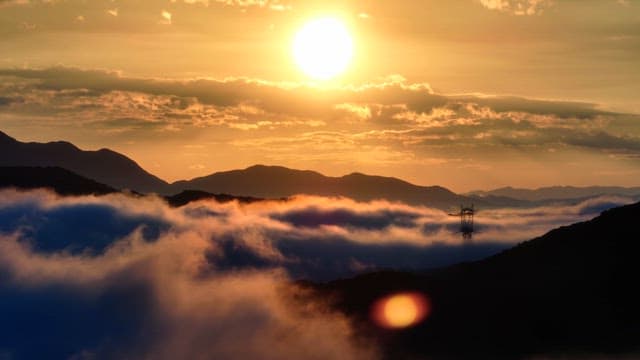 Sunset over mountains with clouds