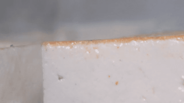 Tofu being fried on a hot pan