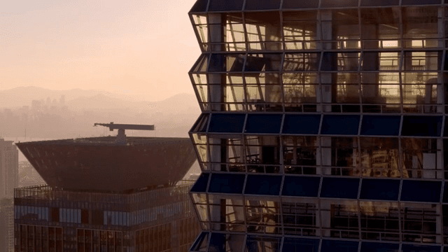 Modern skyscraper reflecting sunset