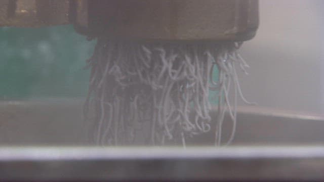 Starch noodles being extruded from a machine