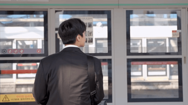 Office worker man sitting on a station chair waiting for the subway