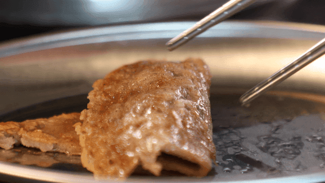Buckwheat pancakes that wrap seasoned vegetables on plate
