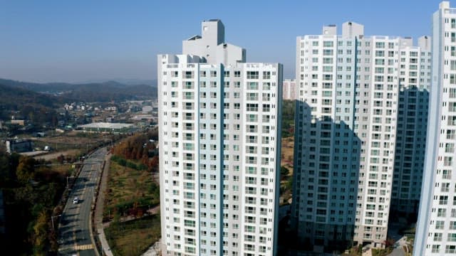 High-Rise Apartment in Front of a Large City Park