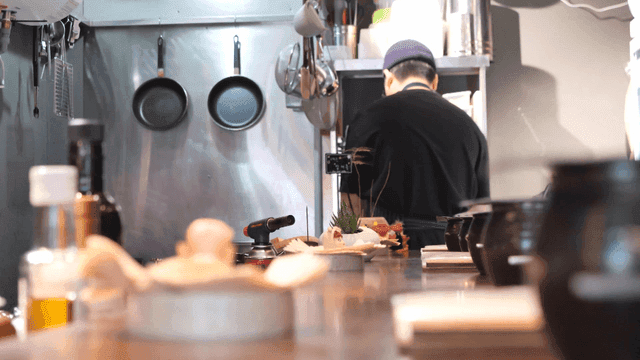 Back view of chef cooking in kitchen