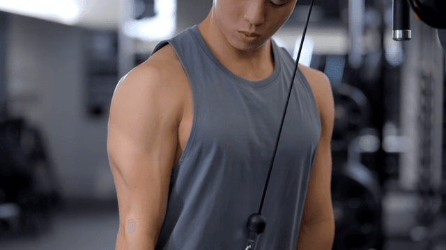 헬스장에서 케이블 머신으로 운동하는 남성