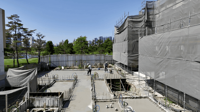 Construction site with workers and cityscape