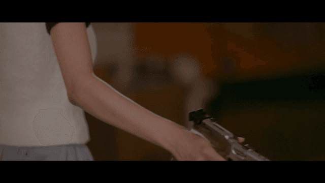 Woman preparing to shoot sport pistol