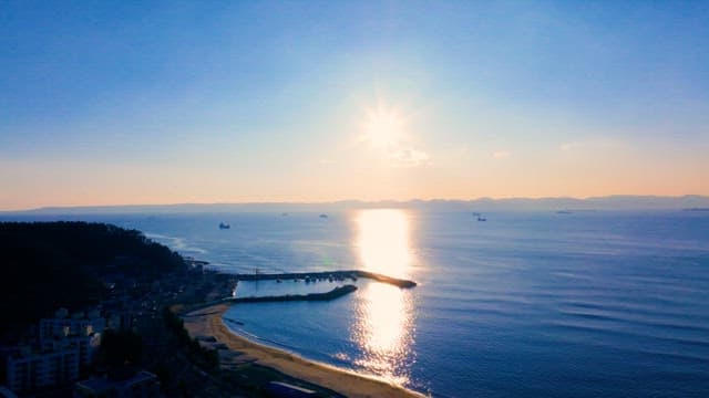 태양이 비치는 고요한 바다와 항구