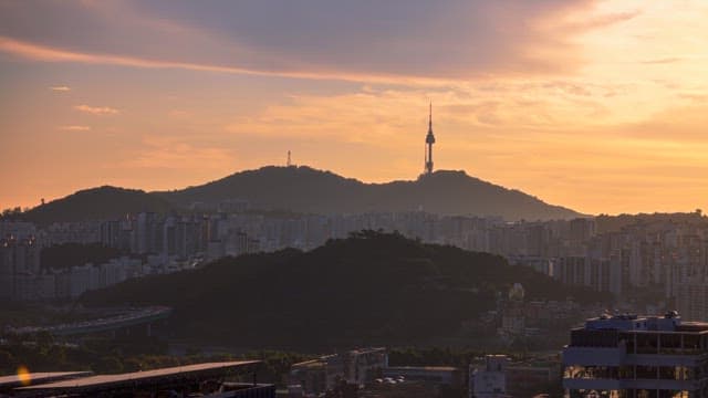 Sunset view of a city skyline with mountains