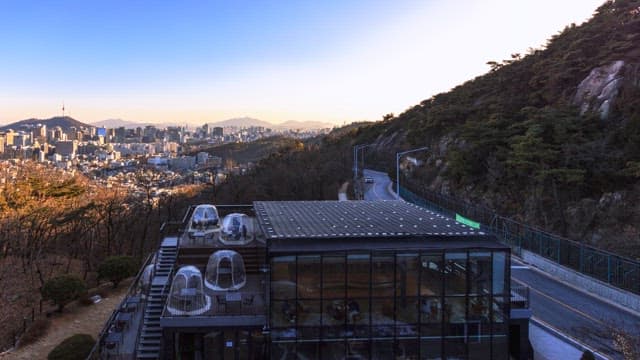 Sunset at a restaurant on a mountainside with the city skyline in the background