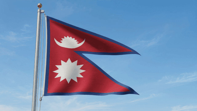 Nepal flag waving against a clear sky