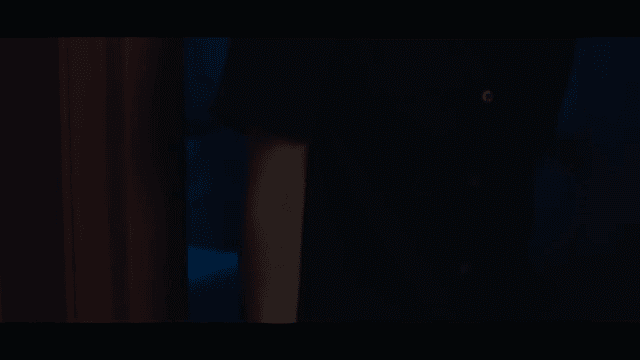 Woman leaving a room carrying a bag