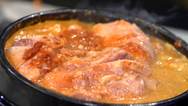 Duck soup boiling in an earthen pot