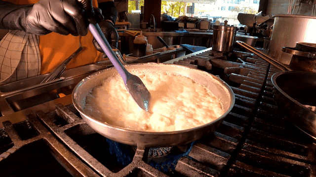 Process of cooking cream sauce in pan on stove