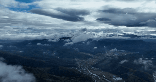 Clouds over a vast mountain landscape