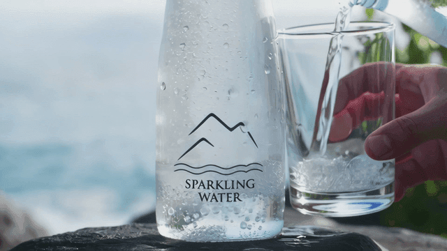 Sparkling water bottle by the sea
