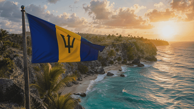 Barbados flag fluttering beside beautiful coastal cliff