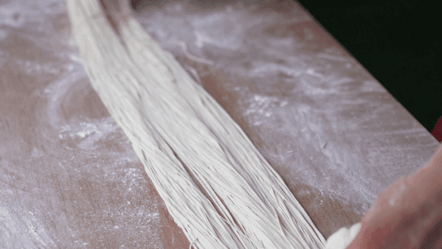 Hand-pulling dough to make noodles