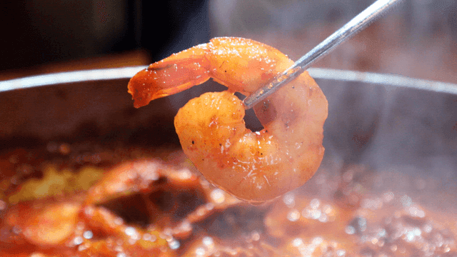 Shrimp being cooked in spicy sauce