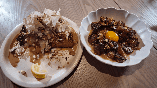Two dishes with unique garnishes on a table