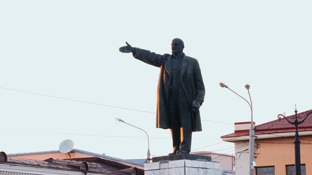 Lenin Statue in the city square during morning light.