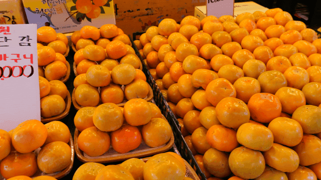 Persimmons displayed at a market stall