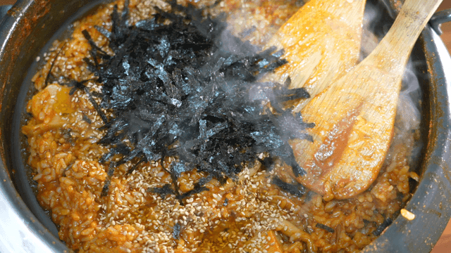 Fried rice topped with sesame seeds and seaweed