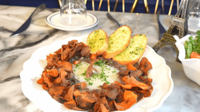 Table with salad and beef bourguignon
